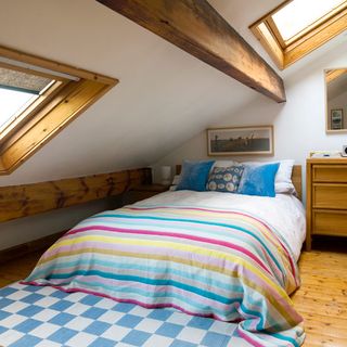 attic bedroom with wooden flooring