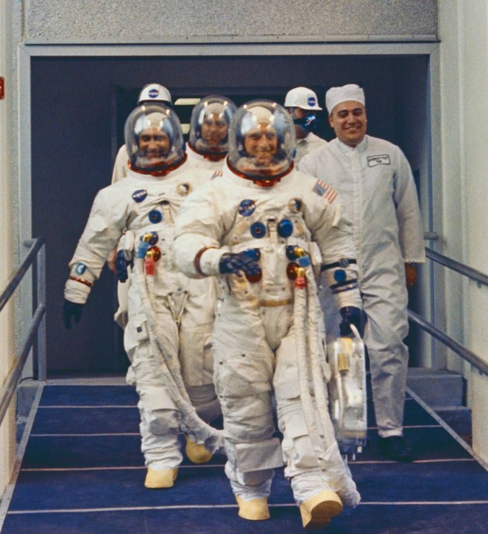 Apollo 12 astronauts Pete Conrad (front) Richard Gordon (left) and Alan Bean (center top in background) walk out to the Astovan for the trip to the launch pad at NASA's Kennedy Space Center in Florida ahead of their Nov. 14, 1969 launch.