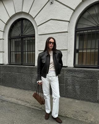 @annabelrosendahl wearing brown loafers with white jeans and top