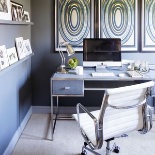 a desk and a chair and a computer in a home office