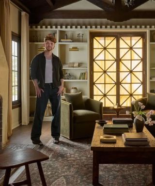 drew of the lone fox photographed in his vintage style living room for the launch of his rug collection with joon loloi