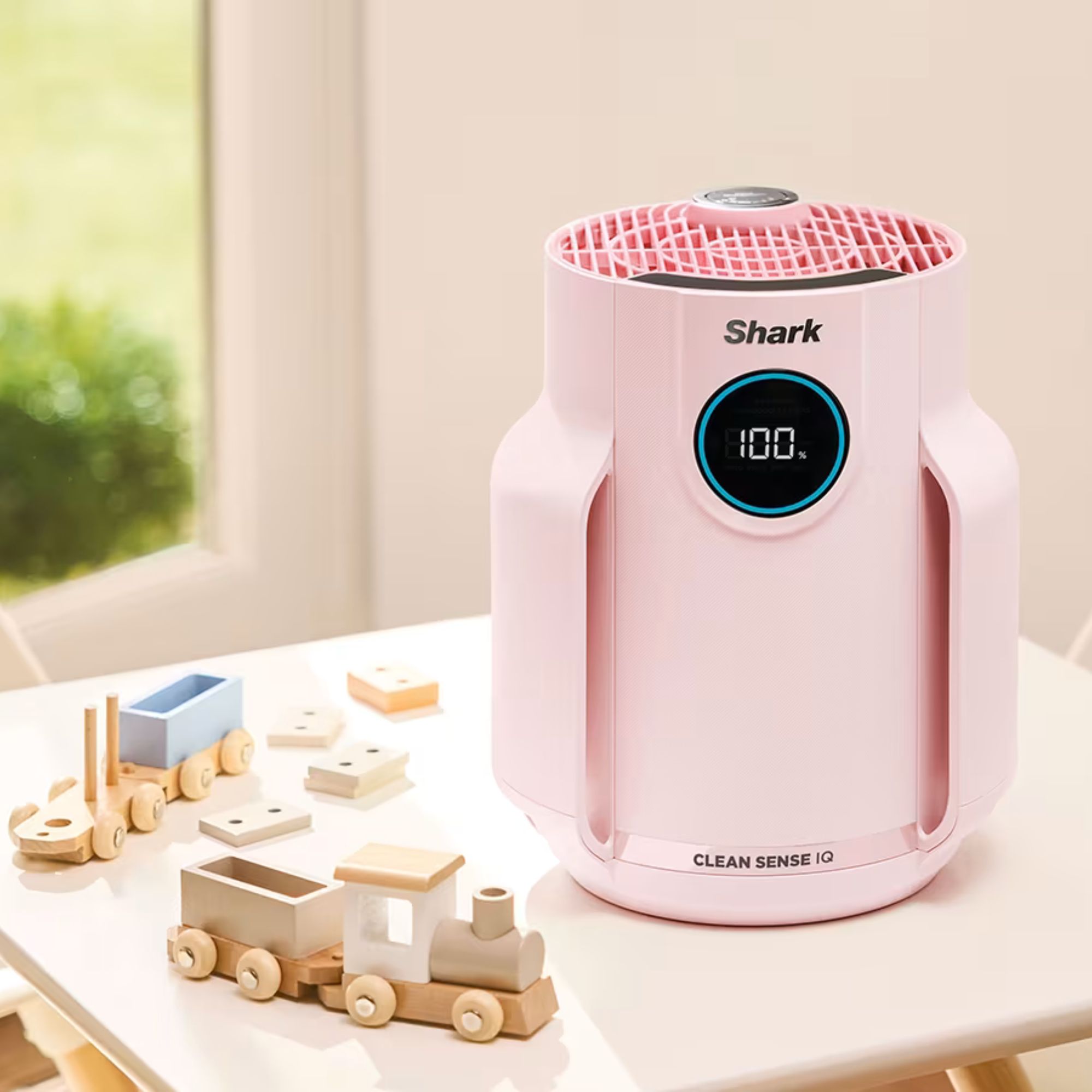 Pink Shark NeverChange5 Air Purifier Compact Pro on a table with kids' toys