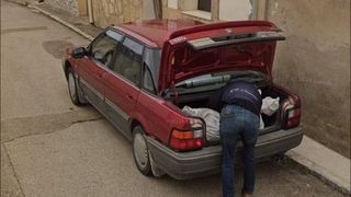 Close up of car with body being dumped