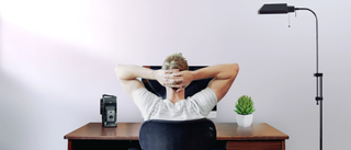 Man relaxing at his desk in a working from home office