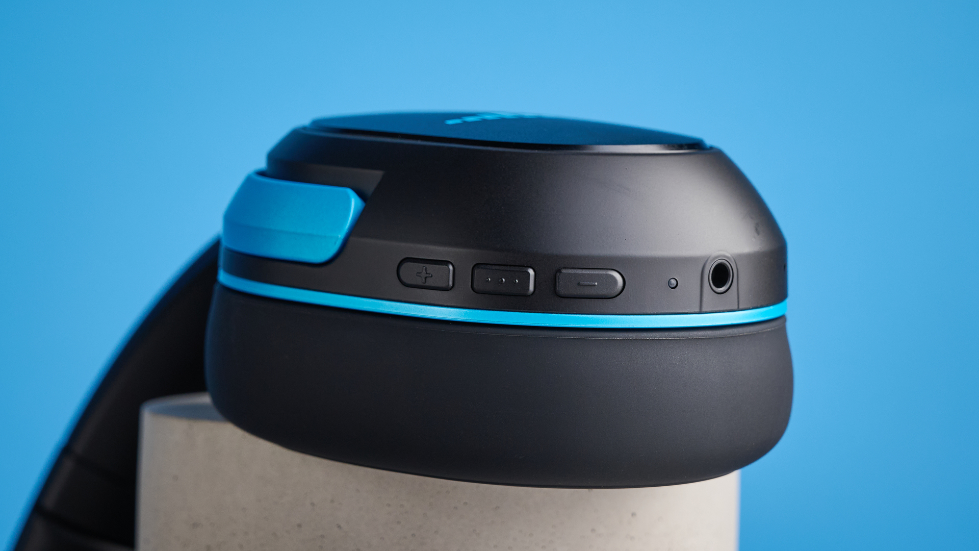 H2O RIPT Ultra headphones in black with blue accents photographed on a blue background