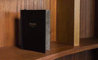 discreet black notebook, which opened up to reveal pages detailing different photographs
