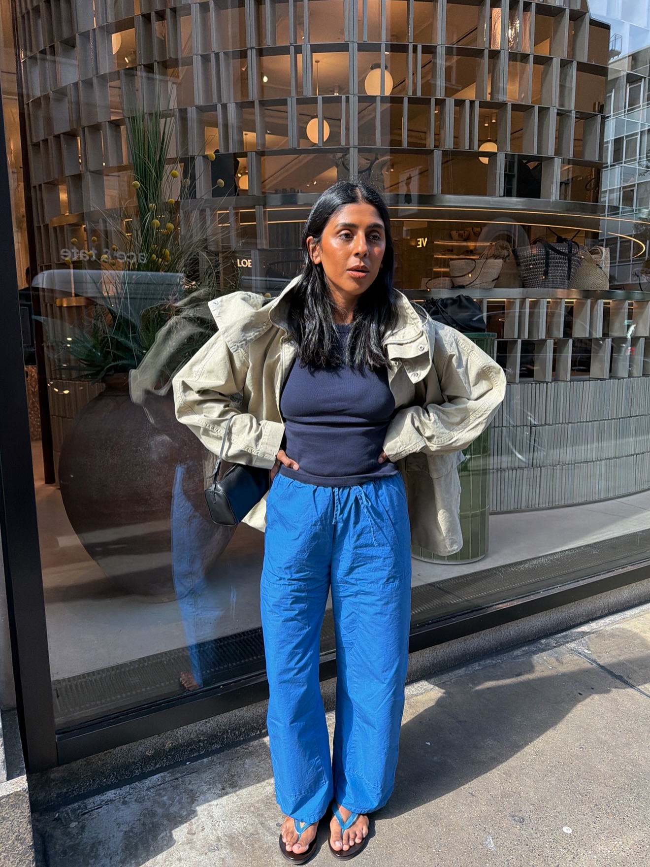 Monikh wears a blue t-shirt, drawstring trousers and sandals