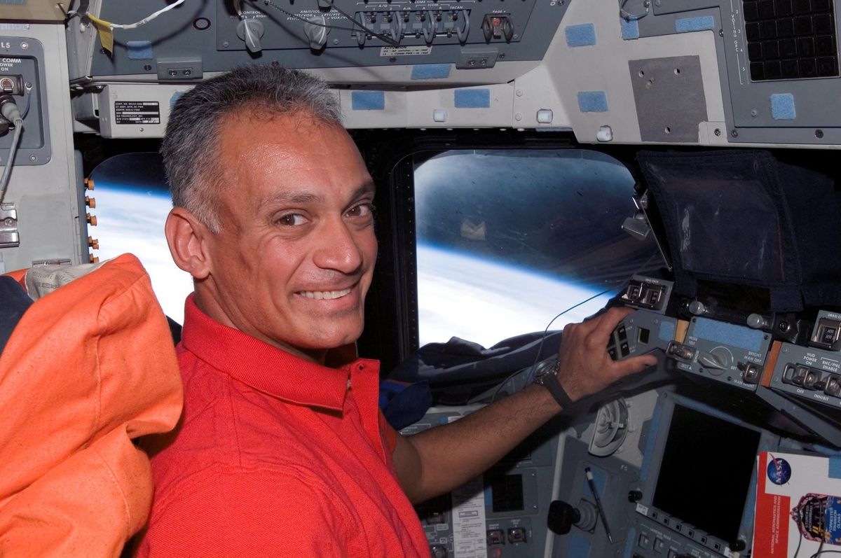 NASA astronaut Danny Olivas smiles on the flight deck of space shuttle Atlantis during the STS-117 mission to the International Space Station in June 2007