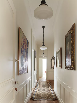 Hallway with pendant lights and artwork