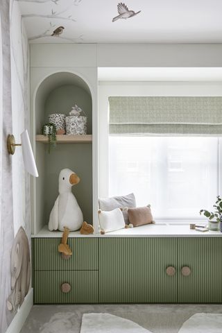 A child's bedroom with window seat and storage