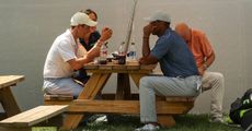 Rory McIlroy and Tiger Woods sat at a picnic bench