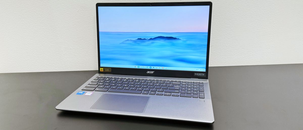 Angled shot of the Acer Chromebook Plus Enterprise 515 facing forward, on a black desk against a white background.