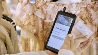 The Samsung Galaxy XCover Pro being used to scan clothing in River Island