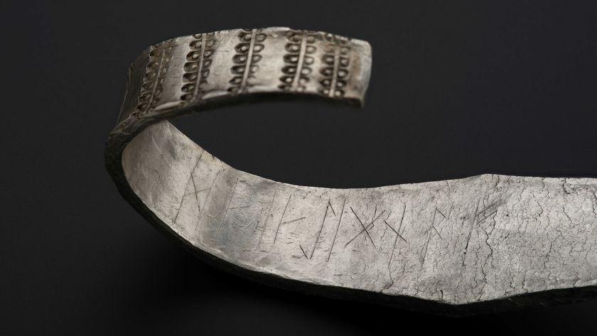 a close-up of a runic inscription on a silver armband