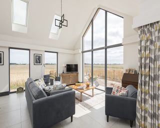 living room with aluminium picture windows and fully glazed gable