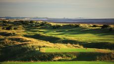 A hole at Silloth on Solway Golf Club with the sea in the background