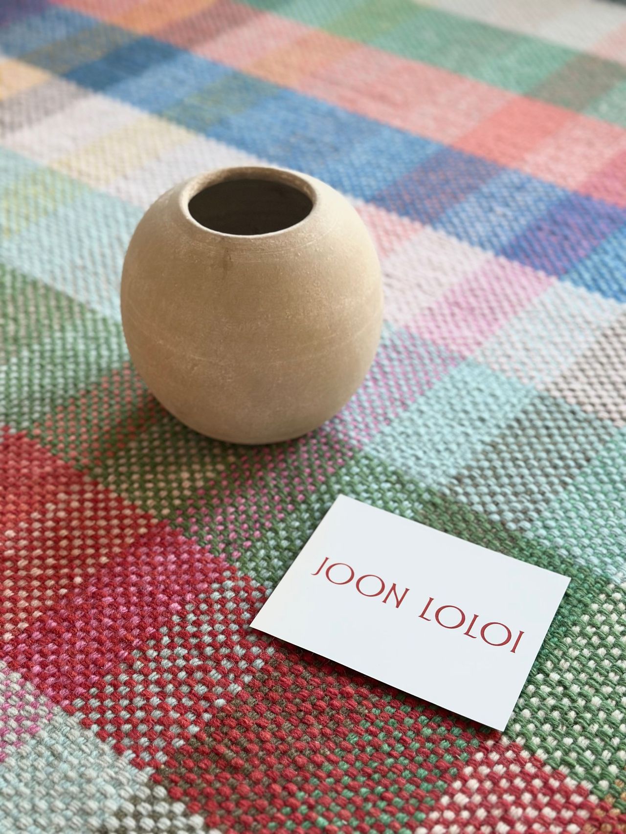 a vase on a checkered tablecloth