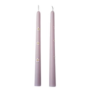 Two purple candlesticks with painted daisies on it
