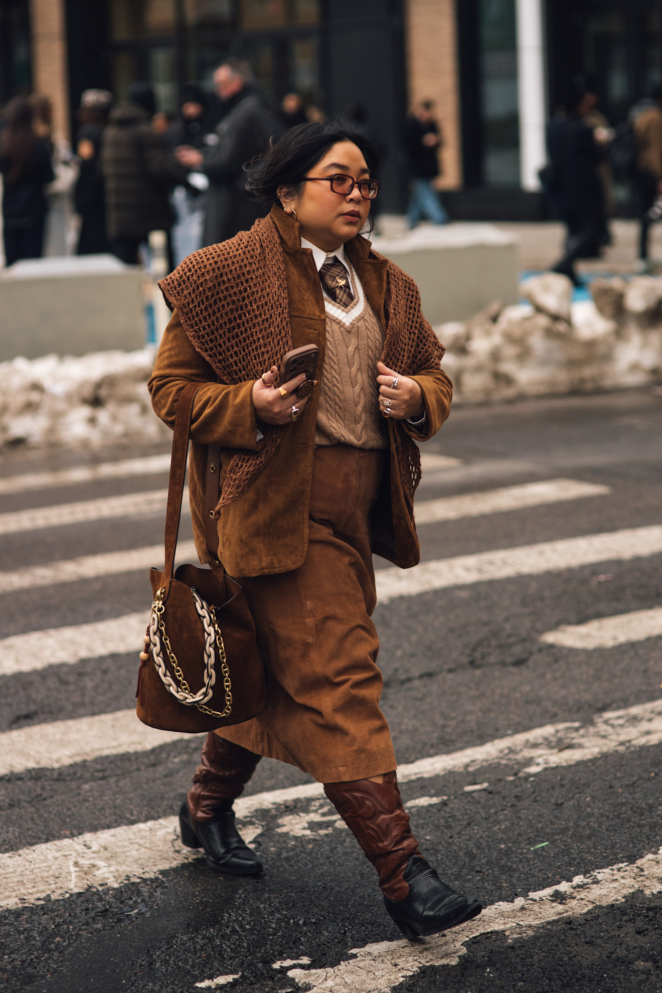 woman wearing blazer, sweater, necktie, skirt, and boots
