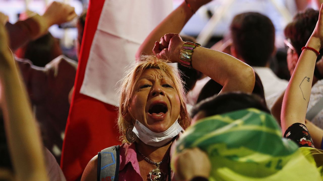 A supporter of Jose Antonio Kast celebrates as the first-round vote is counted 