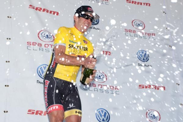 Andy Jacques-Maynes (Kenda-5 Hour Energy) lets his victory champagne fly following his leader's jersey podium presentation.