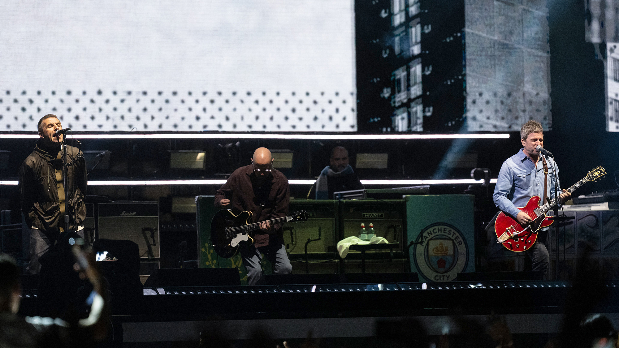 Liam Gallagher (L) and Noel Gallagher (R) of Oasis perform onstage during the opening night of their Live 25' Tour at the Principality Stadium on July 04, 2025 in Cardiff, Wales