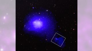 A gassy blue ball of a galaxy with a long, cloudy tail trailing behind it to the bottom right 