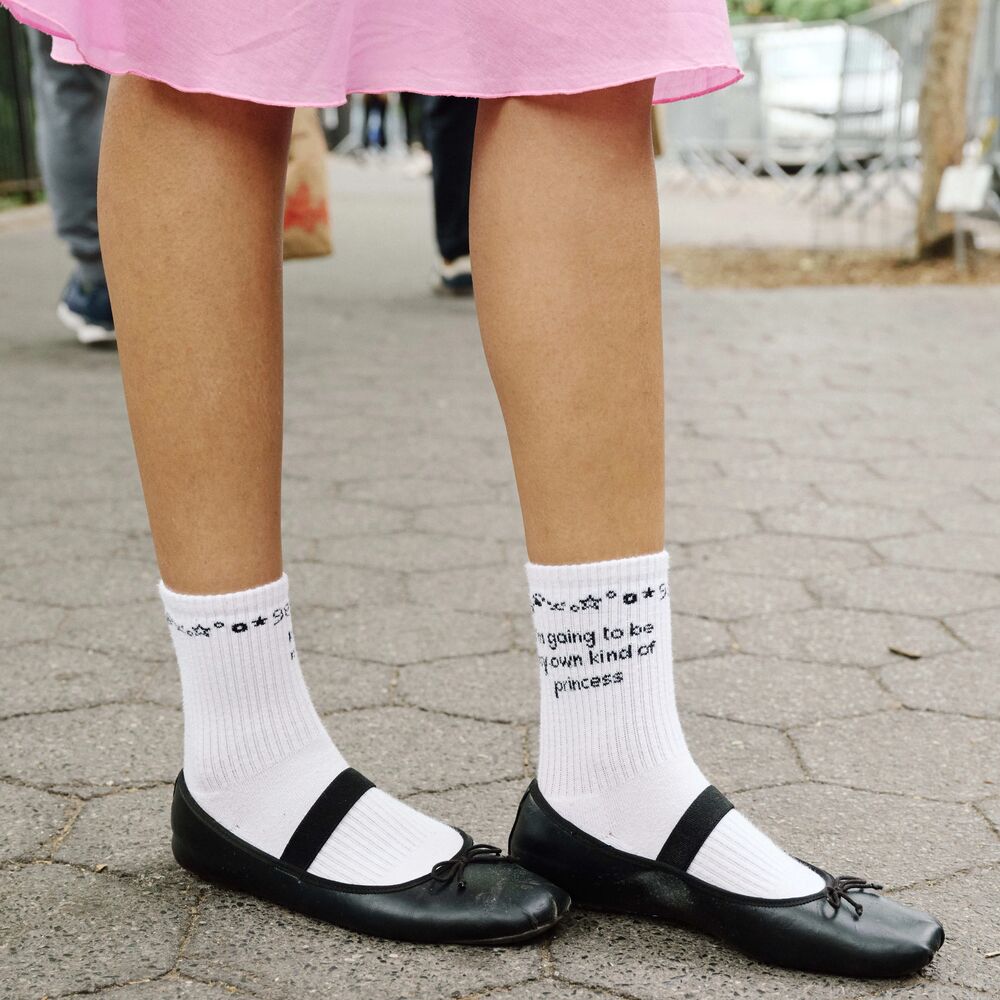 Black ballet flats worn with white socks.