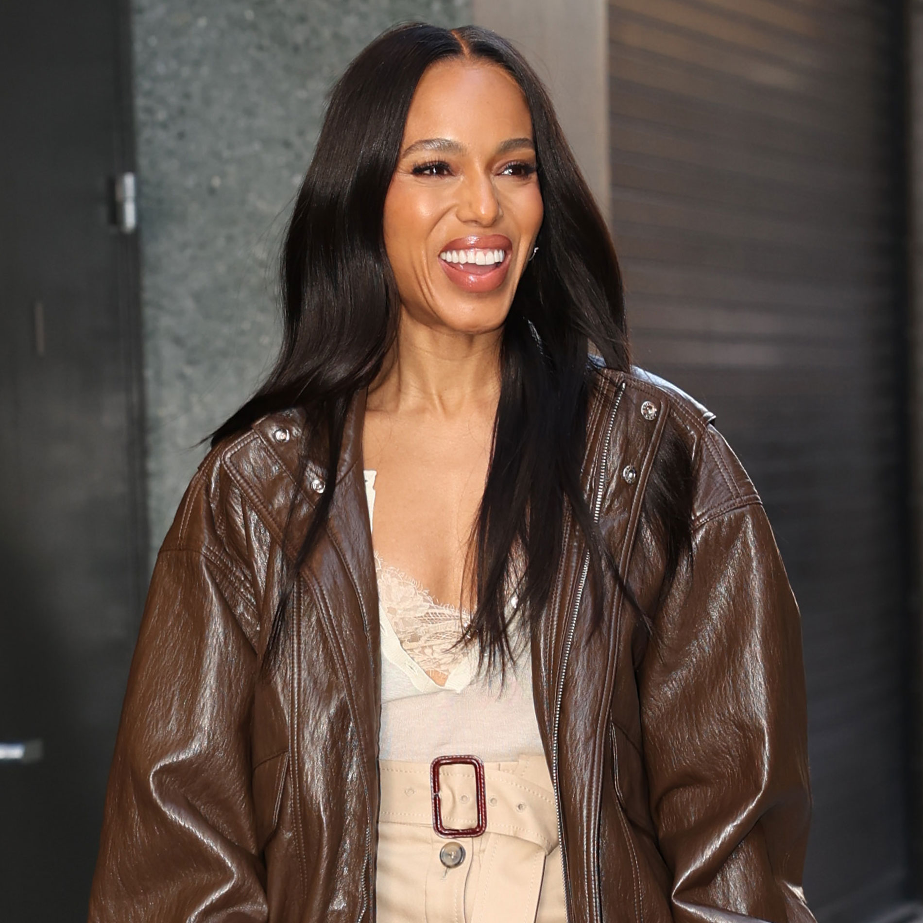 Kerry Washington wears a brown jacket