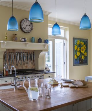 Yellow kitchen with hanging blue light fixtures