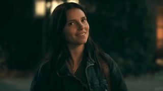 A screenshot of Inde Navarrette as Nikki looking at the camera with a smile in Obsession.