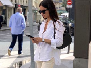 French Woman Shopping Sale on Phone Wearing a White Button Down Shirt