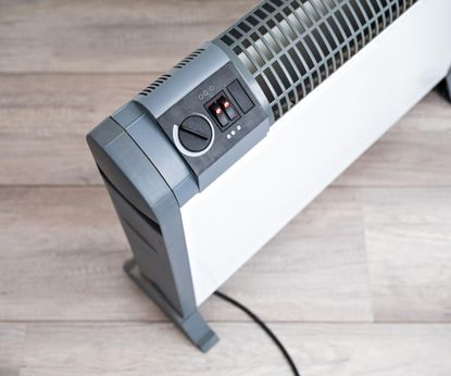 Best types of space heater: An electric heater on a light wood floor