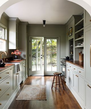 Galley kitchen ideas with sage green and wood floor