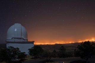 This view of the Rock House wildfire was shot on the night of April 9 from the catwalk of the 6.9-foot (2.1-meter) Otto Struve Telescope dome looking east. The 8.9-foot (2.7-m) Harlan J. Smith Telescope is at left.