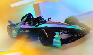 Dynamic image of 2024 Formula E car emerging from smoke at the Season 9 launch event