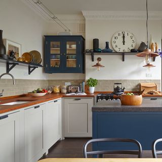 kitchen with cream walls and blue cabinet