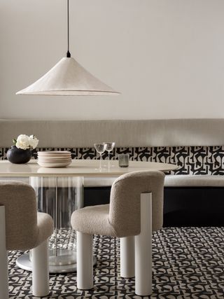 A kitchen with geometric black and white patterned floor tiles