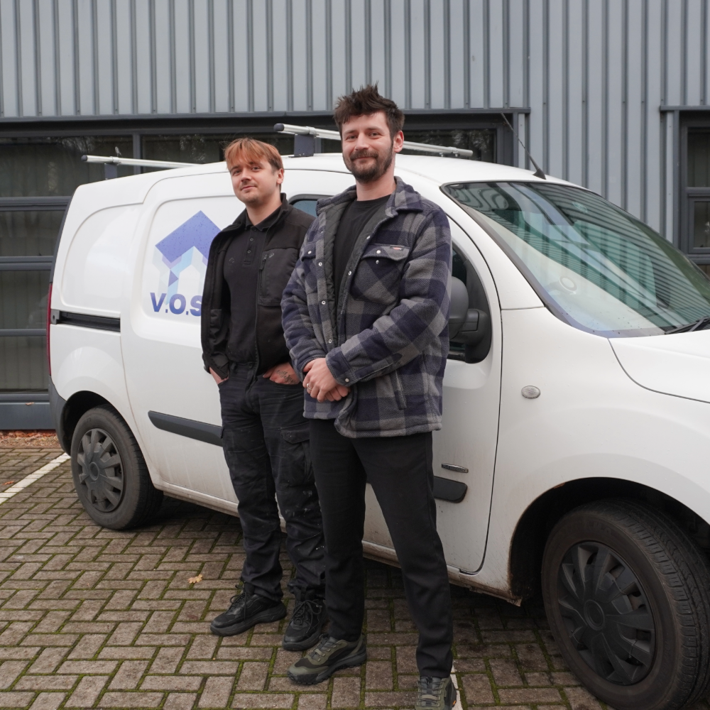 Oliver and Vic Slovak standing in front of a company van