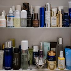 A photo of beauty and skincare products on a bathroom shelf cabinet