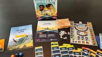 The Sky Team box, board, instruction booklets, and components on a wooden table