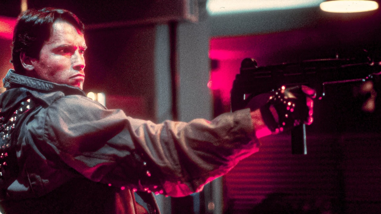 A still from The Terminator showing Arnold Schwarzenegger's terminator holding a gun