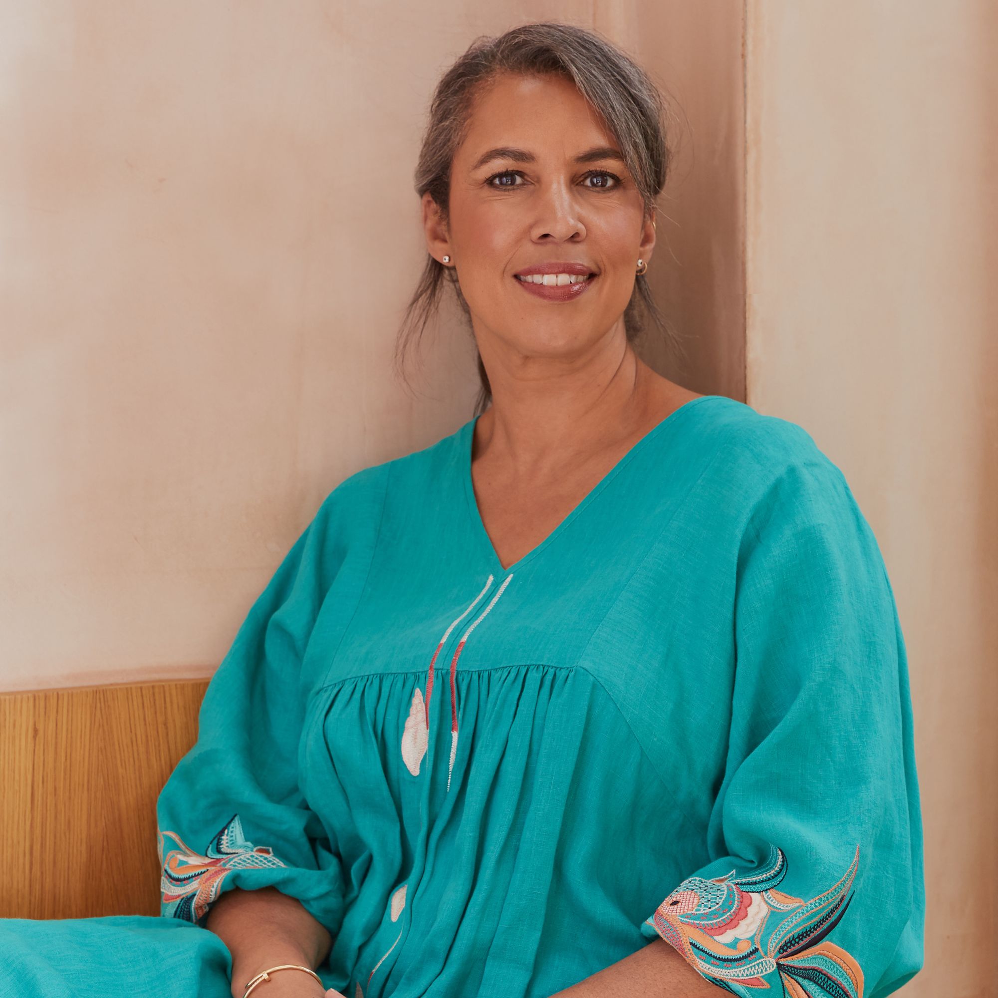 A headshot of Max Mckenzie in a blue dress