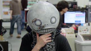 NieR creator Yoko Taro in his trademark Emil mask from the games