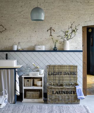 rustic style utility space with wicker laundry basket and freestanding storage unit