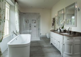 bathroom with grey cabinet and bath tub