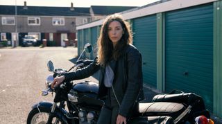 Bridget Christie standing next to a classic motorbike in new comedy drama The Change.