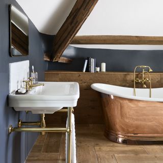 brass freestanding bath in cottage bathroom