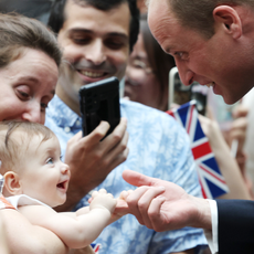 8 month old Albane Costa holds the finger of Prince William, Prince of Wales during his visit to the HSBC Rain Vortex at Jewel Changi Airport on day one of his visit to Singapore on November 05, 2023 in Singapore.