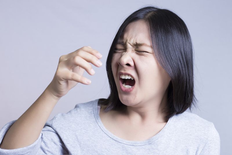 woman sneezing